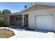 Charming exterior features a brick facade, manicured landscaping, and an attached garage at 6221 13Th N Ave, St Petersburg, FL 33710