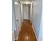 Hallway with hardwood floors and white trim, providing access to multiple rooms at 6221 13Th N Ave, St Petersburg, FL 33710