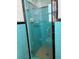Bathroom featuring a retro glass shower stall with teal tiling and chrome fixtures at 6221 13Th N Ave, St Petersburg, FL 33710