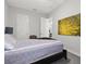 Bright bedroom featuring neutral walls, white trim, and striking abstract art at 6313 Brevada Ln, Apollo Beach, FL 33572