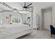 Bright bedroom featuring a four-poster bed, patterned floor tiles, and ample natural light at 6313 Brevada Ln, Apollo Beach, FL 33572