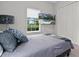 Comfortable bedroom with a mounted TV showing pool view, neutral color scheme, and natural light at 6313 Brevada Ln, Apollo Beach, FL 33572
