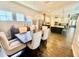 Dining area with modern chandelier, wooden table with seating for six, and view to kitchen at 6313 Brevada Ln, Apollo Beach, FL 33572