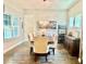 Bright dining room with a chandelier, seating for six, and two bright windows at 6313 Brevada Ln, Apollo Beach, FL 33572