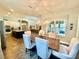 Dining area with a decorative chandelier, seating for six, and a view of the kitchen at 6313 Brevada Ln, Apollo Beach, FL 33572