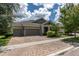 Well-maintained home featuring a three-car garage, brick driveway, and beautifully landscaped front yard at 6313 Brevada Ln, Apollo Beach, FL 33572