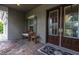 Charming front porch area with double doors, a bench, stylish mat and stone pavers at 6313 Brevada Ln, Apollo Beach, FL 33572