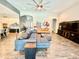 Bright living room featuring a ceiling fan, tiled floors, and two leather couches at 6313 Brevada Ln, Apollo Beach, FL 33572