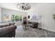 Inviting living room featuring stylish seating, a window with lush views, and unique decor at 6313 Brevada Ln, Apollo Beach, FL 33572