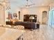Open-concept living room with modern furnishings, tiled floors, and a view to dining area at 6313 Brevada Ln, Apollo Beach, FL 33572