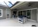 Spacious covered patio with stylish outdoor seating, ideal for entertaining at 6313 Brevada Ln, Apollo Beach, FL 33572