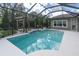 Relaxing screened pool with a pergola and lush landscaping at 6313 Brevada Ln, Apollo Beach, FL 33572