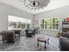Sitting Room with comfortable leather chairs, tile flooring, a windmill ceiling fan, and lots of windows at 6313 Brevada Ln, Apollo Beach, FL 33572