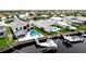 Aerial view of the waterfront home with a private pool, boat dock, and serene water views for luxurious outdoor living at 684 Regatta Way, Bradenton, FL 34208