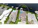 Aerial view of two homes, a boat dock, and a small island in the water at 684 Regatta Way, Bradenton, FL 34208
