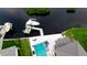 Aerial view showcasing waterfront property featuring a pool, boat lift, and a dock for enjoying the water at 684 Regatta Way, Bradenton, FL 34208