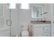 This bathroom features a shower with a glass enclosure, a vanity with a sink, and light gray decor at 684 Regatta Way, Bradenton, FL 34208