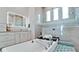 Luxurious bathroom features a soaking tub, rain shower, and illuminated mirror, offering a spa-like experience at 684 Regatta Way, Bradenton, FL 34208