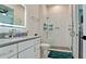 The bathroom features a shower with white subway tile, vanity and sink with a lighted mirror at 684 Regatta Way, Bradenton, FL 34208