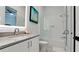 The bathroom includes a vanity with sink, a lighted mirror, and a shower and tub with glass enclosure at 684 Regatta Way, Bradenton, FL 34208