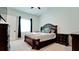 A traditional-style bedroom features carpet flooring and a dark wood bedroom set at 684 Regatta Way, Bradenton, FL 34208