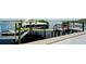 Boat lift and dock with a motorized boat and jet skis on the water at 684 Regatta Way, Bradenton, FL 34208