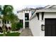 Modern home with a paver walkway, manicured lawn, and elegant black trim at 684 Regatta Way, Bradenton, FL 34208