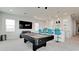This game room features a pool table, a bar with stools, and a large screen television at 684 Regatta Way, Bradenton, FL 34208