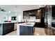 Spacious kitchen with dark cabinets, a center island, and modern appliances, perfect for culinary enthusiasts at 684 Regatta Way, Bradenton, FL 34208