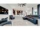 Open floor plan showcases a modern living room with sleek tile flooring and views of the kitchen and staircase at 684 Regatta Way, Bradenton, FL 34208