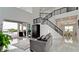 Open living room with soaring ceilings, staircase, and sliding glass doors that open to the outdoor patio and pool at 684 Regatta Way, Bradenton, FL 34208
