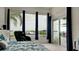 Bedroom with stunning water views through large windows, enhanced by stylish curtains, creating a serene retreat at 684 Regatta Way, Bradenton, FL 34208