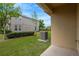 View of the green backyard, house exterior, and manicured landscaping, perfect for outdoor enjoyment at 7029 White Treetop Pl, Riverview, FL 33578