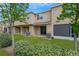 The back of the home features a well-maintained lawn, covered patios, and mature trees at 7029 White Treetop Pl, Riverview, FL 33578