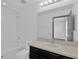 Bathroom featuring a tub/shower combo, white tile, and a vanity with a sink at 7029 White Treetop Pl, Riverview, FL 33578