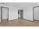 A spacious bedroom with hardwood floors, three doorways, and neutral decor at 7029 White Treetop Pl, Riverview, FL 33578