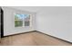 Bedroom featuring a large window allowing for ample natural light and hardwood floors at 7029 White Treetop Pl, Riverview, FL 33578