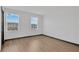 Bright bedroom with two windows allowing for ample natural light and hardwood floors at 7029 White Treetop Pl, Riverview, FL 33578