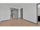 Bedroom featuring hardwood floors and three doorways to other rooms at 7029 White Treetop Pl, Riverview, FL 33578