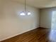 Dining room with wooden floors, hanging chandelier, and neutral paint at 7029 White Treetop Pl, Riverview, FL 33578