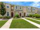 Inviting townhome exteriors with manicured lawns and sidewalks leading to each front door at 7029 White Treetop Pl, Riverview, FL 33578
