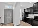 Modern kitchen featuring sleek black appliances, white counters and light wood floors at 7029 White Treetop Pl, Riverview, FL 33578