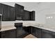 Contemporary kitchen with dark cabinets, light countertops and stainless steel sink at 7029 White Treetop Pl, Riverview, FL 33578