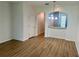 Living room with wood flooring, an open archway, and a staircase in the background at 7029 White Treetop Pl, Riverview, FL 33578