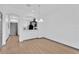 Bright, open-concept living space with hardwood floors, leading into the kitchen at 7029 White Treetop Pl, Riverview, FL 33578