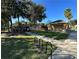 A grassy area shows a sidewalk leading to a park area with a playground and a covered picnic area at 7029 White Treetop Pl, Riverview, FL 33578