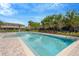 Inviting community swimming pool with a clear blue water, surrounded by a brick patio and landscaping at 7029 White Treetop Pl, Riverview, FL 33578