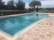 A pristine community pool with a brick patio, inviting residents to relax and enjoy a refreshing swim in a serene setting at 7029 White Treetop Pl, Riverview, FL 33578