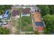 Aerial view showcases brown roof, light-blue house with large grassy backyard, and neighboring house at 8505 N Brooks St, Tampa, FL 33604