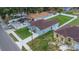 Aerial view of a single-Gathering home with an asphalt roof, fenced yard and several parked cars at 8505 N Brooks St, Tampa, FL 33604